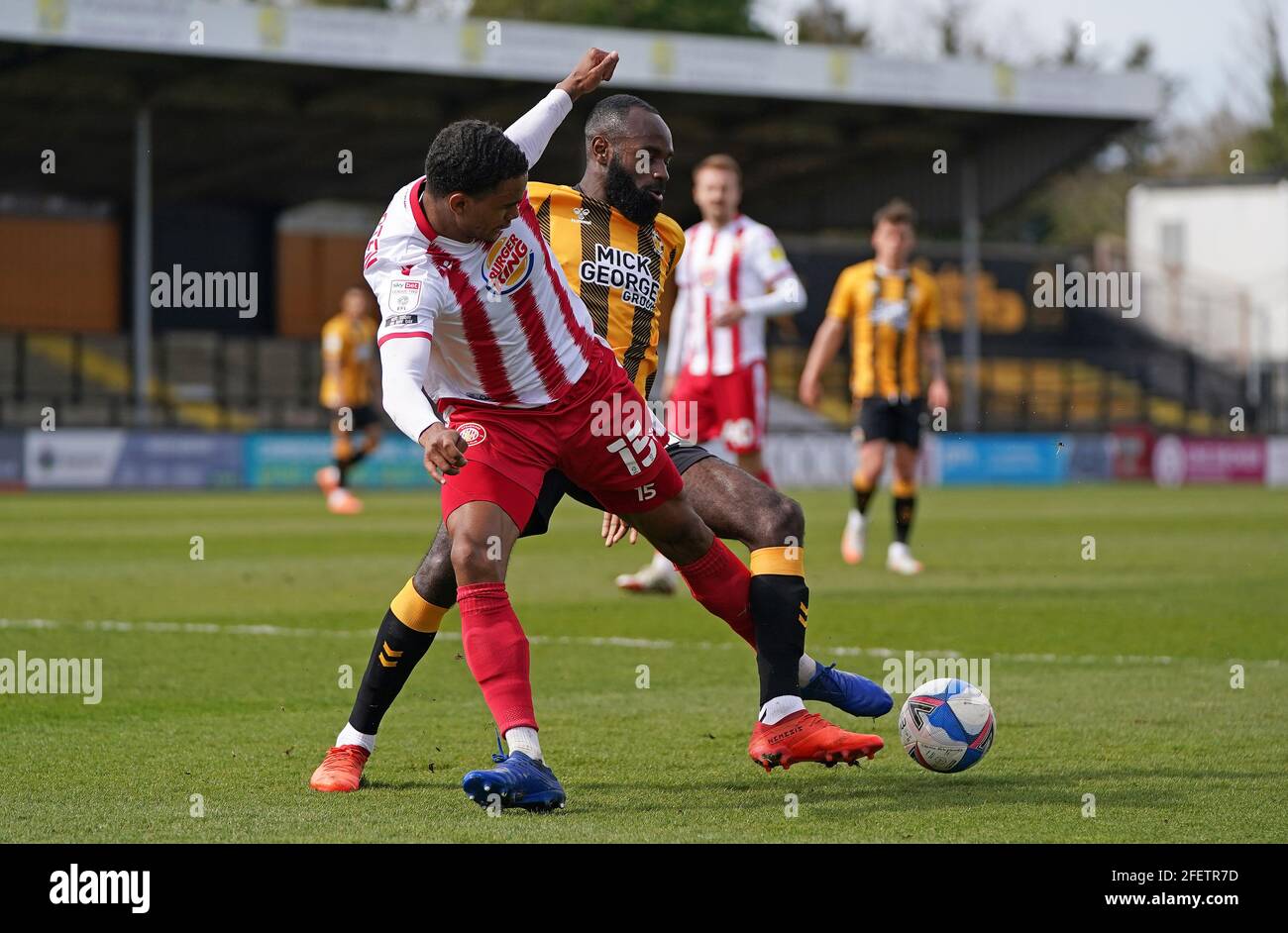 Stevenage's Terence Vancooten (left) and Cambridge United's Hiram Boateng battle for the ball during the Sky Bet League Two match at Abbey Stadium, Cambridge. Picture date: Saturday April 24, 2021. Stock Photo