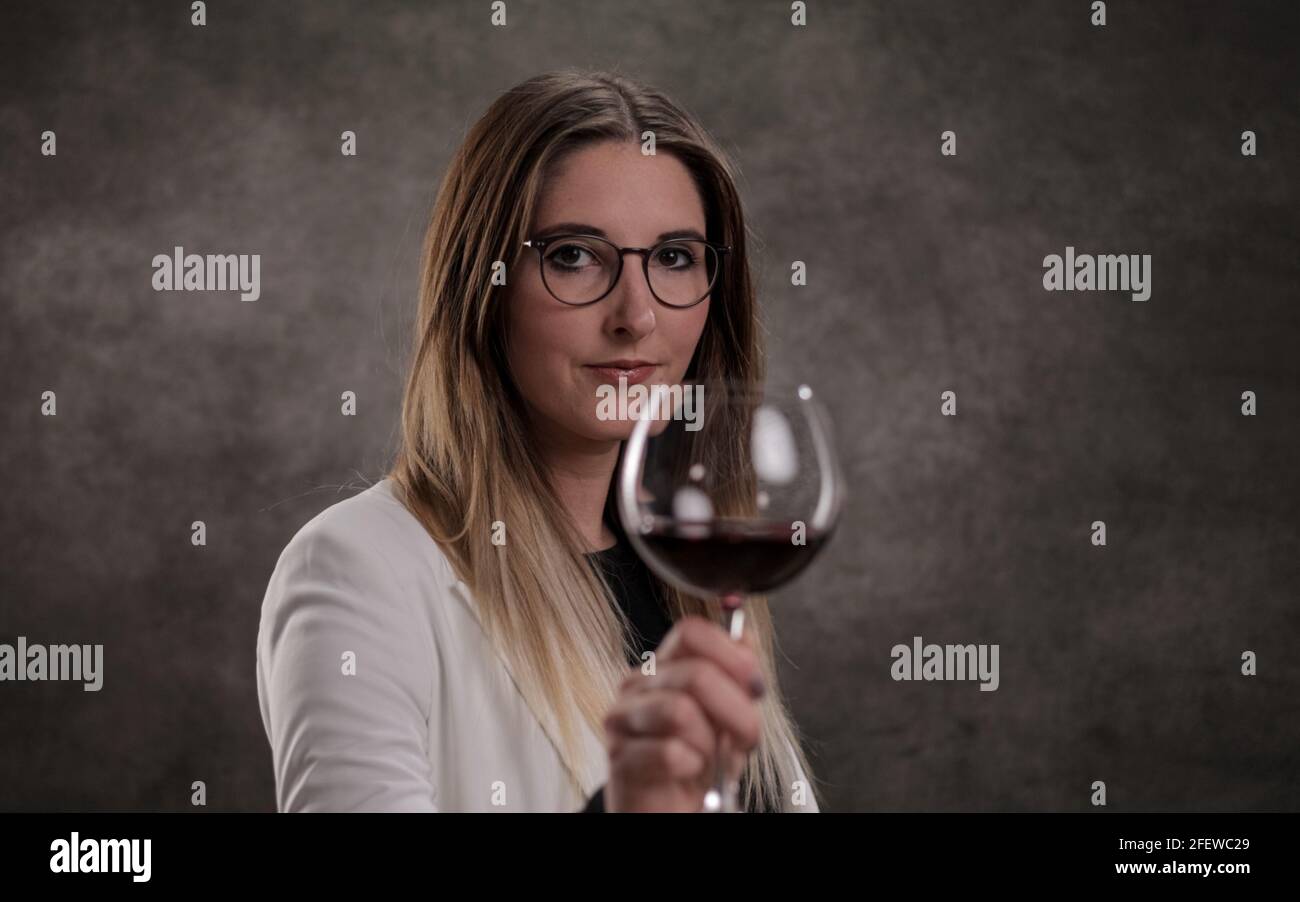 Young woman with a glass of red wine Stock Photo - Alamy