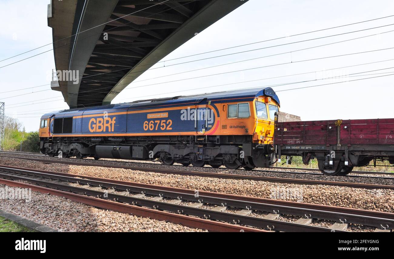 Class 66, near Hitchin, providing rear assistance for a long, heavy train of ballast and concrete sleepers for the London King's Cross remodelling Stock Photo