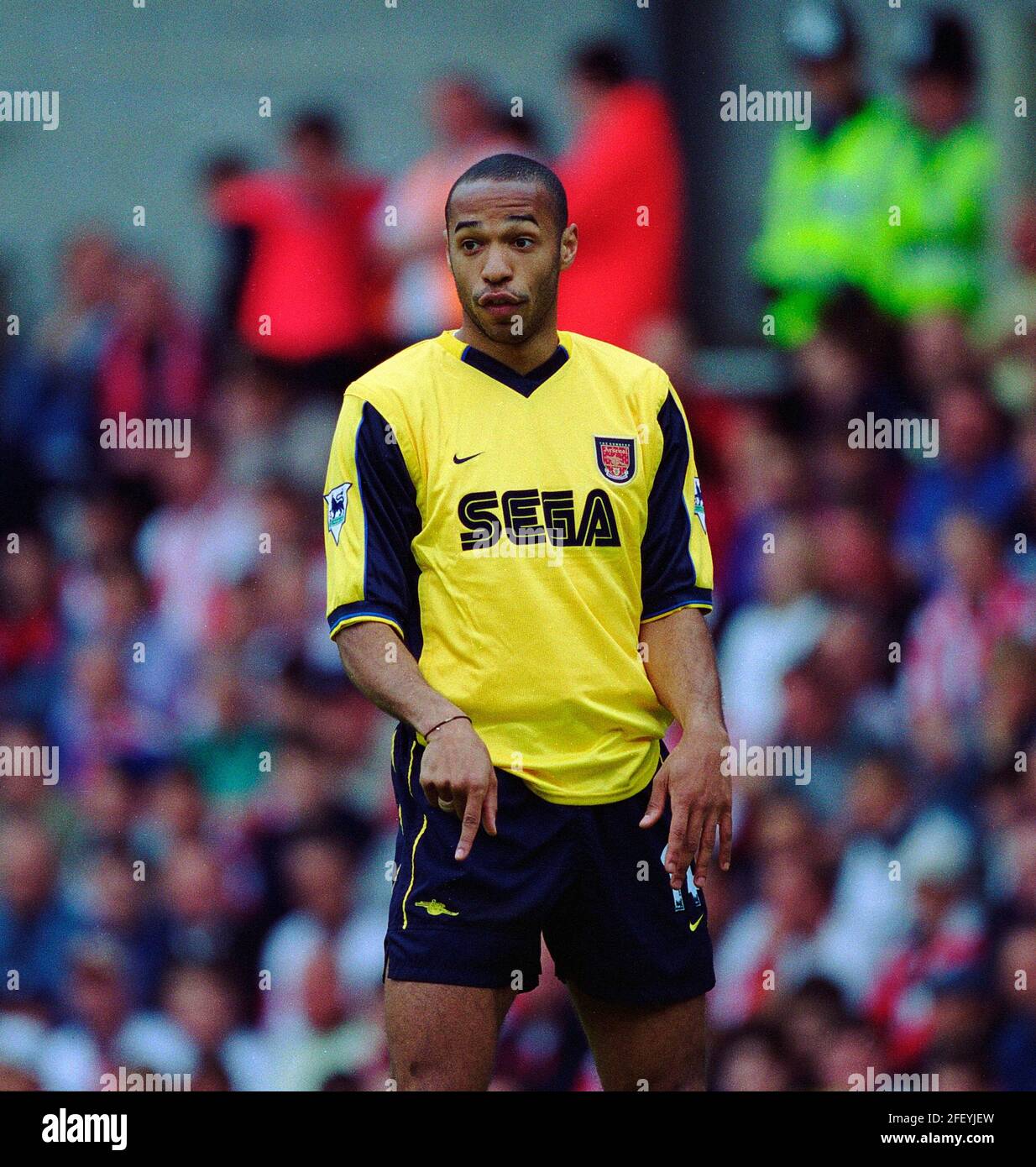 Thierry Henry playing for Arsenal wearing the Sega yellow away kit of the 1999-2001 season.This image is bound by Dataco restrictions on how it can be used. EDITORIAL USE ONLY No use with unauthorised audio, video, data, fixture lists, club/league logos or “live” services. Online in-match use limited to 120 images, no video emulation. No use in betting, games or single club/league/player publications Stock Photo
