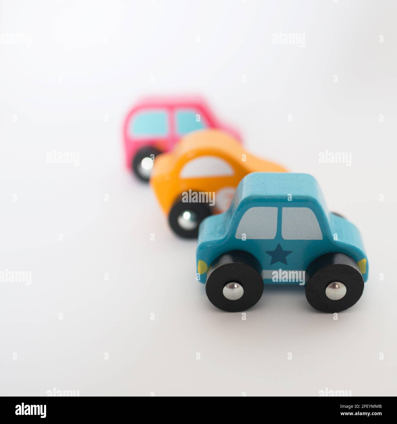 Three colorful toy cars in a row with white background Stock Photo Alamy