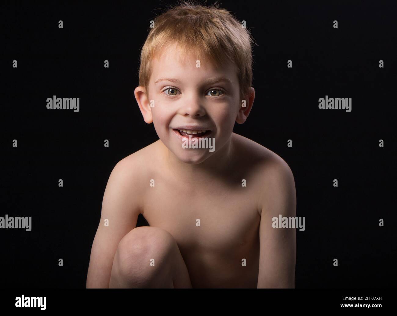 Young boy poses for the camera beforeDreamy pose bed Stock Photo Alamy