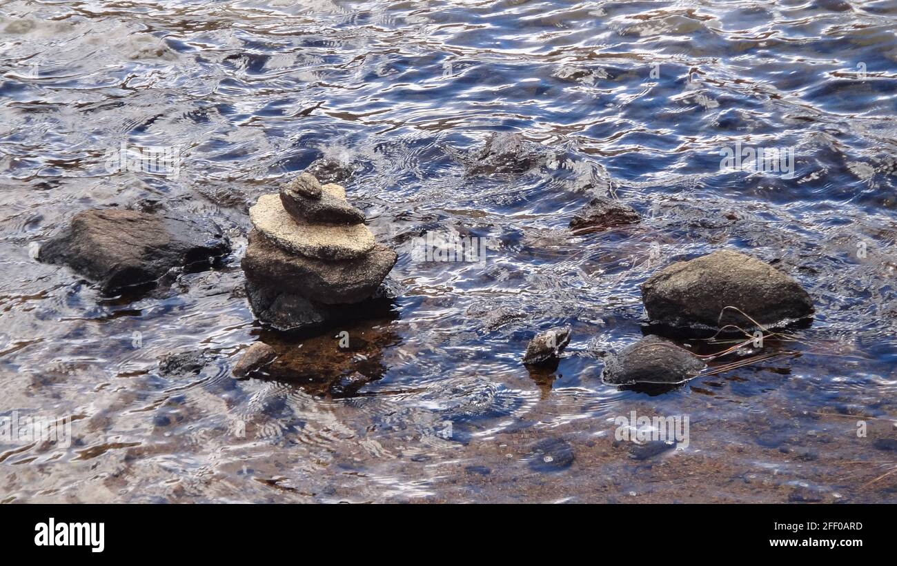 Closeup shot of piled stones in the stream Stock Photo - Alamy