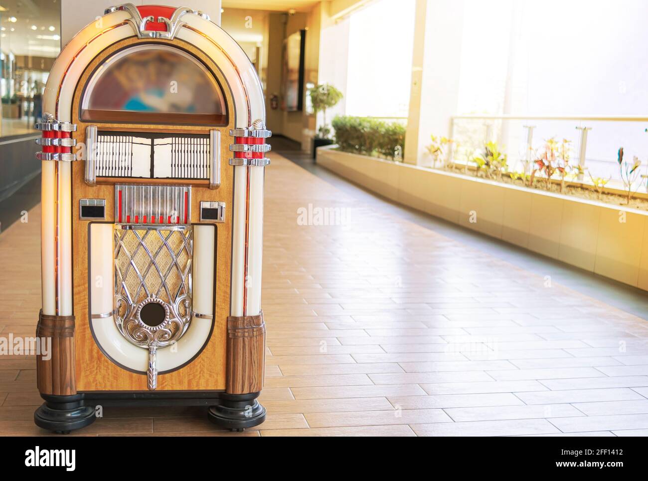 ld retro vintage jukebox in a diner blasting old time music hits with neon lights, Rockola vintage. Stock Photo