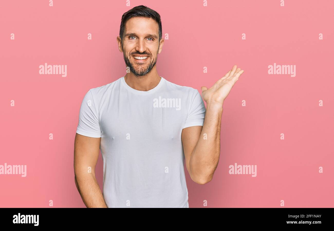 Handsome man with beard wearing casual white t shirt smiling cheerful ...