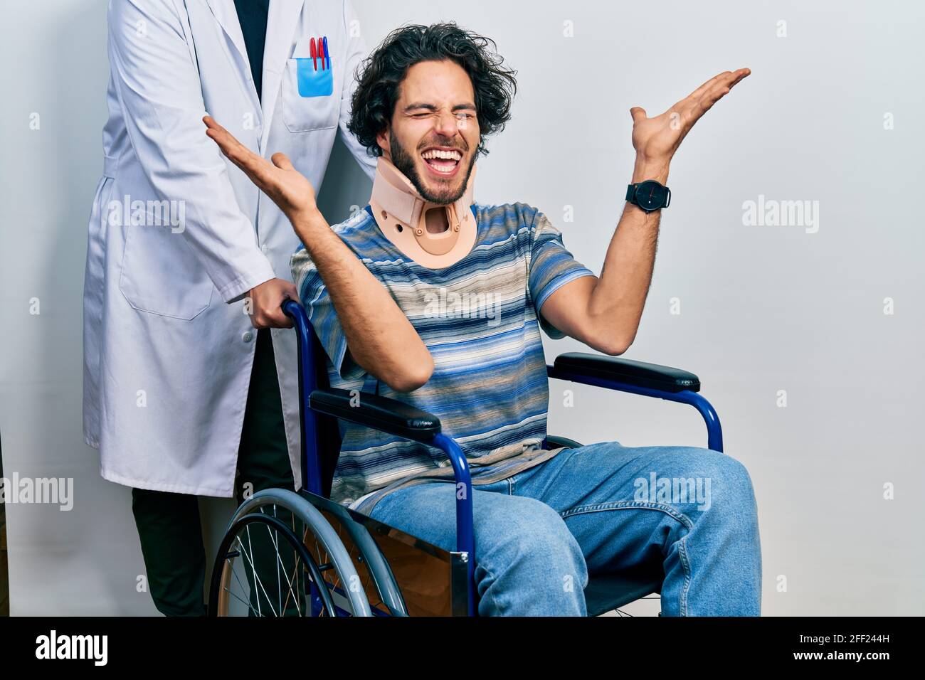 Handsome Hispanic Man Sitting On Wheelchair Wearing Neck Collar 