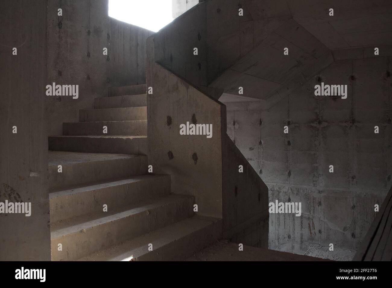 raw concrete stairs with sunlight and shadow at construction site Stock Photo