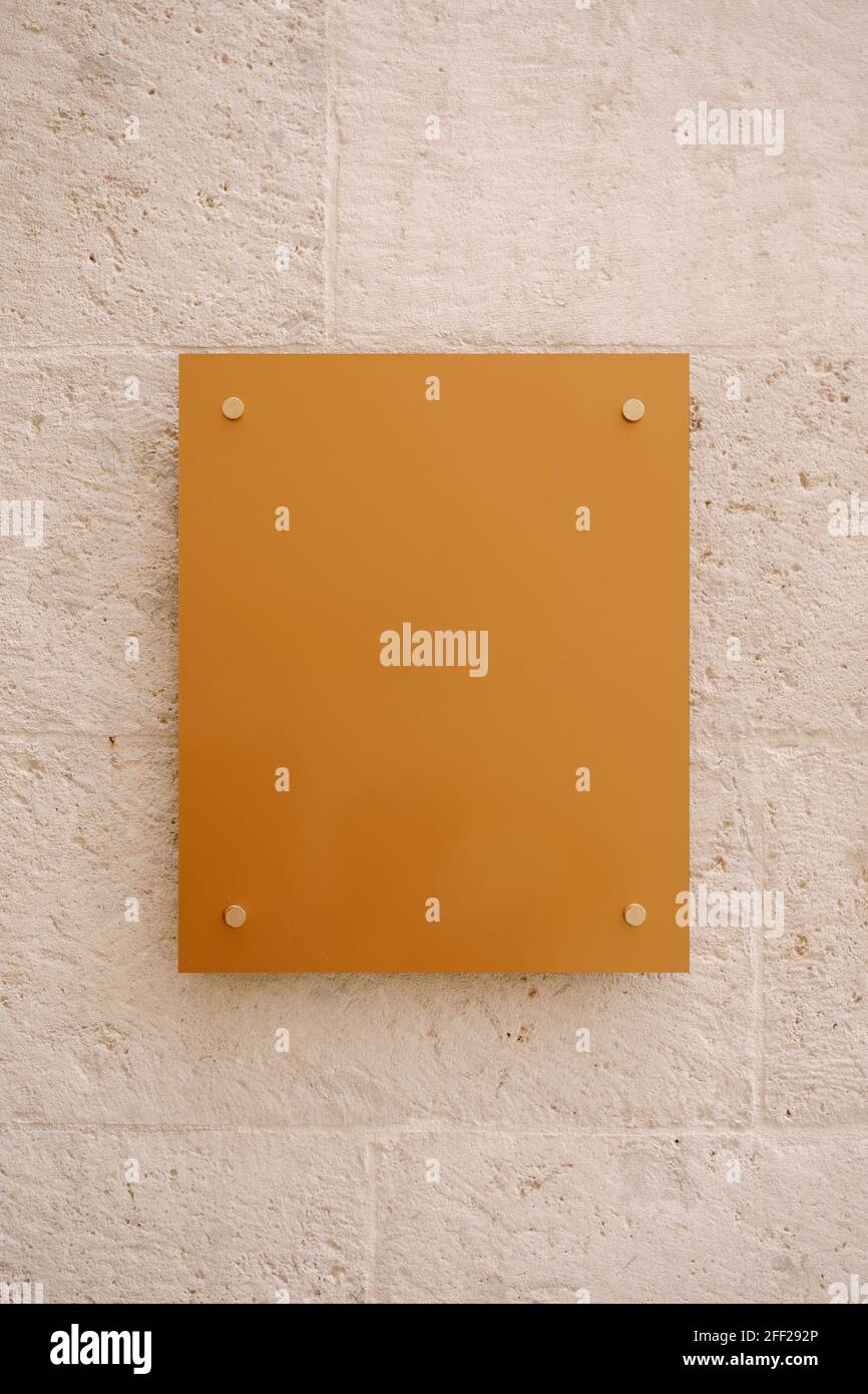 Modern empty rectangular board hanging on stone wall Stock Photo