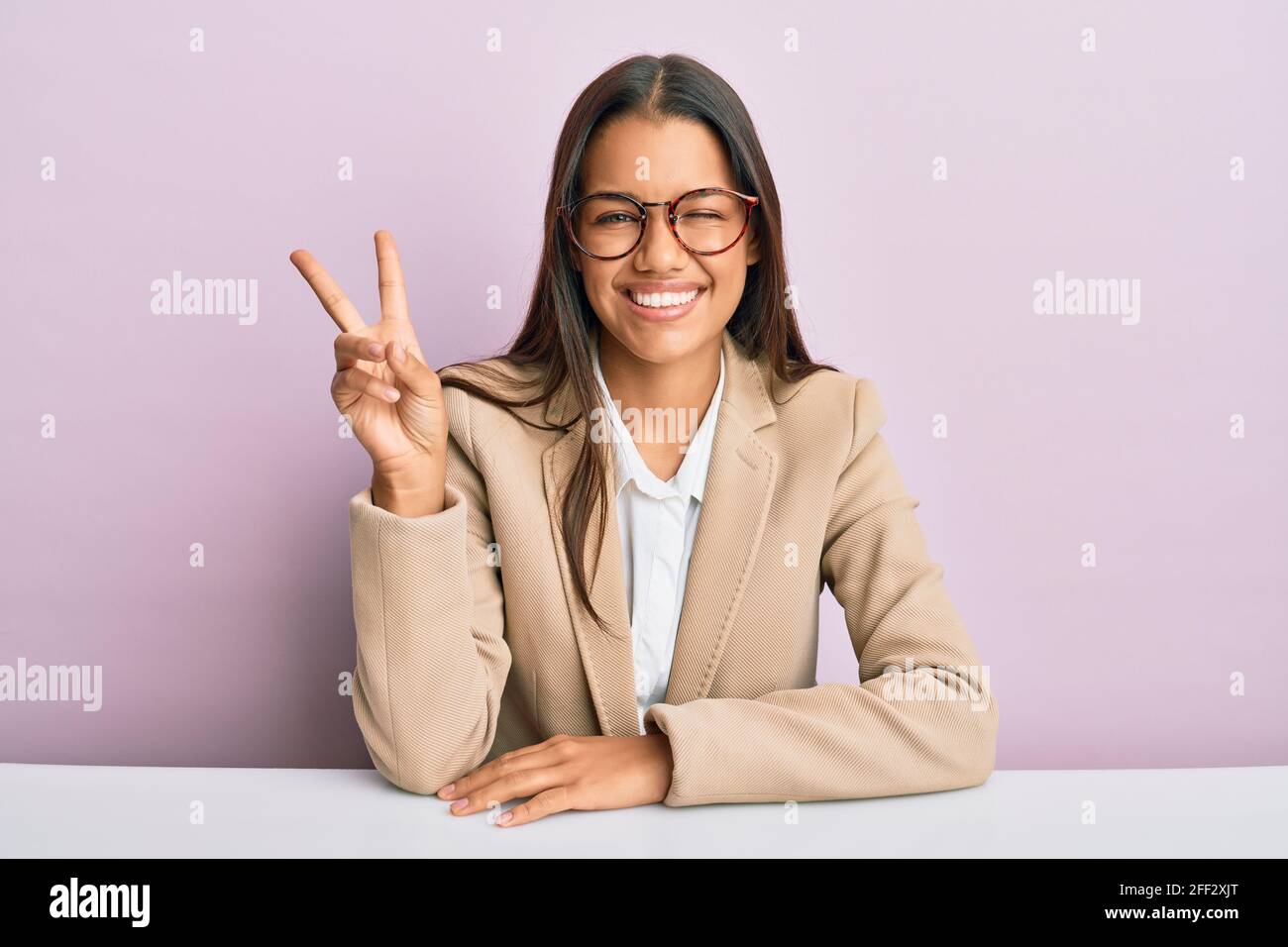 Beautiful hispanic woman working at the office smiling with happy face ...
