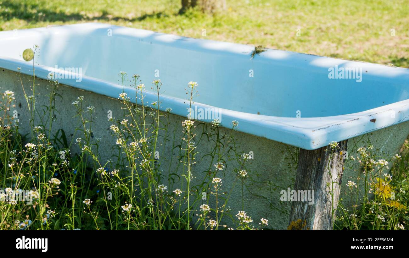 Discarded bathtub in the field Stock Photo