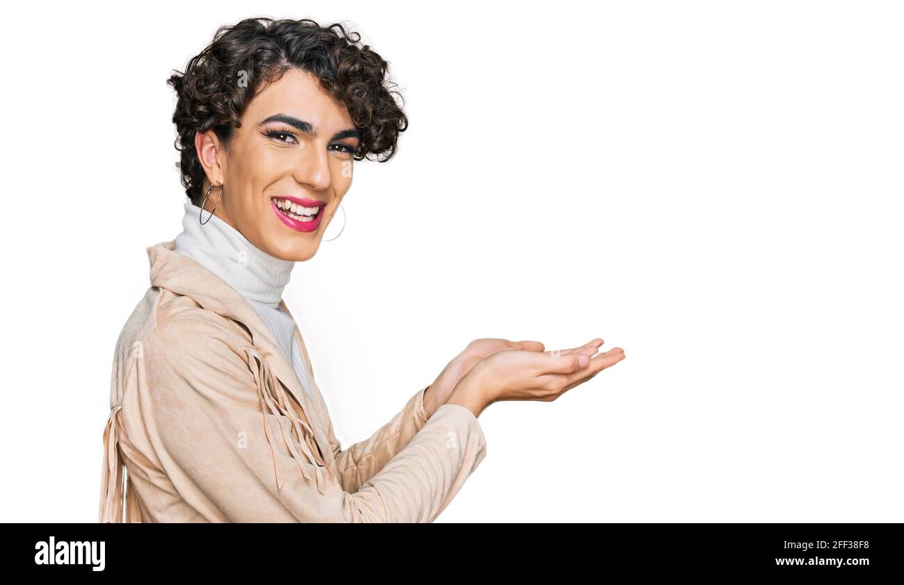 Handsome man wearing make up and woman clothes pointing aside with hands open palms showing copy space, presenting advertisement smiling excited happy Stock Photo