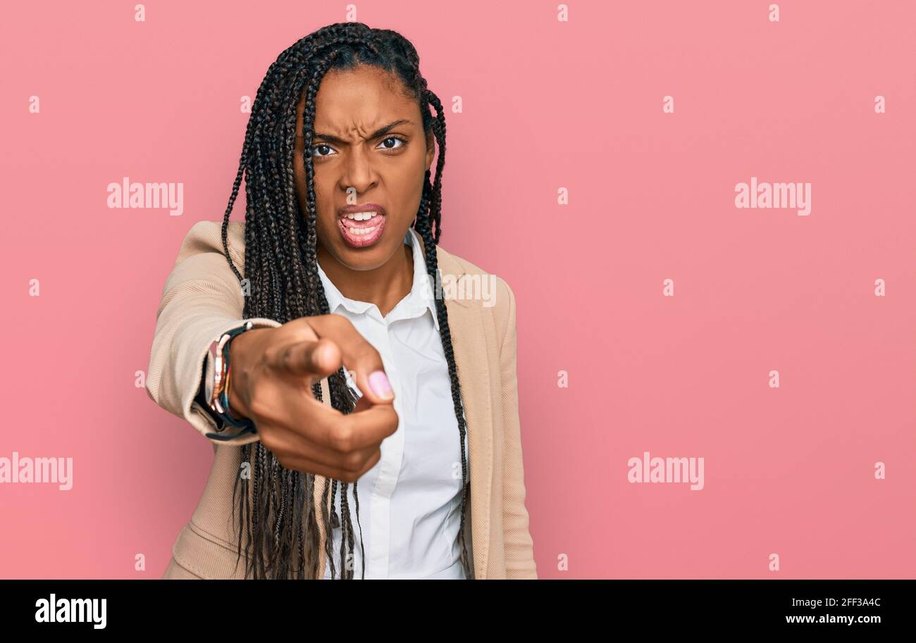 African american woman wearing business jacket pointing displeased and ...