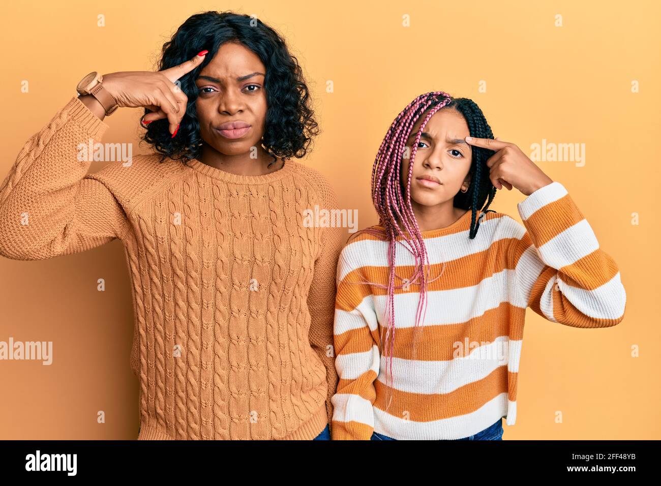 Beautiful african american mother and daughter wearing wool winter ...