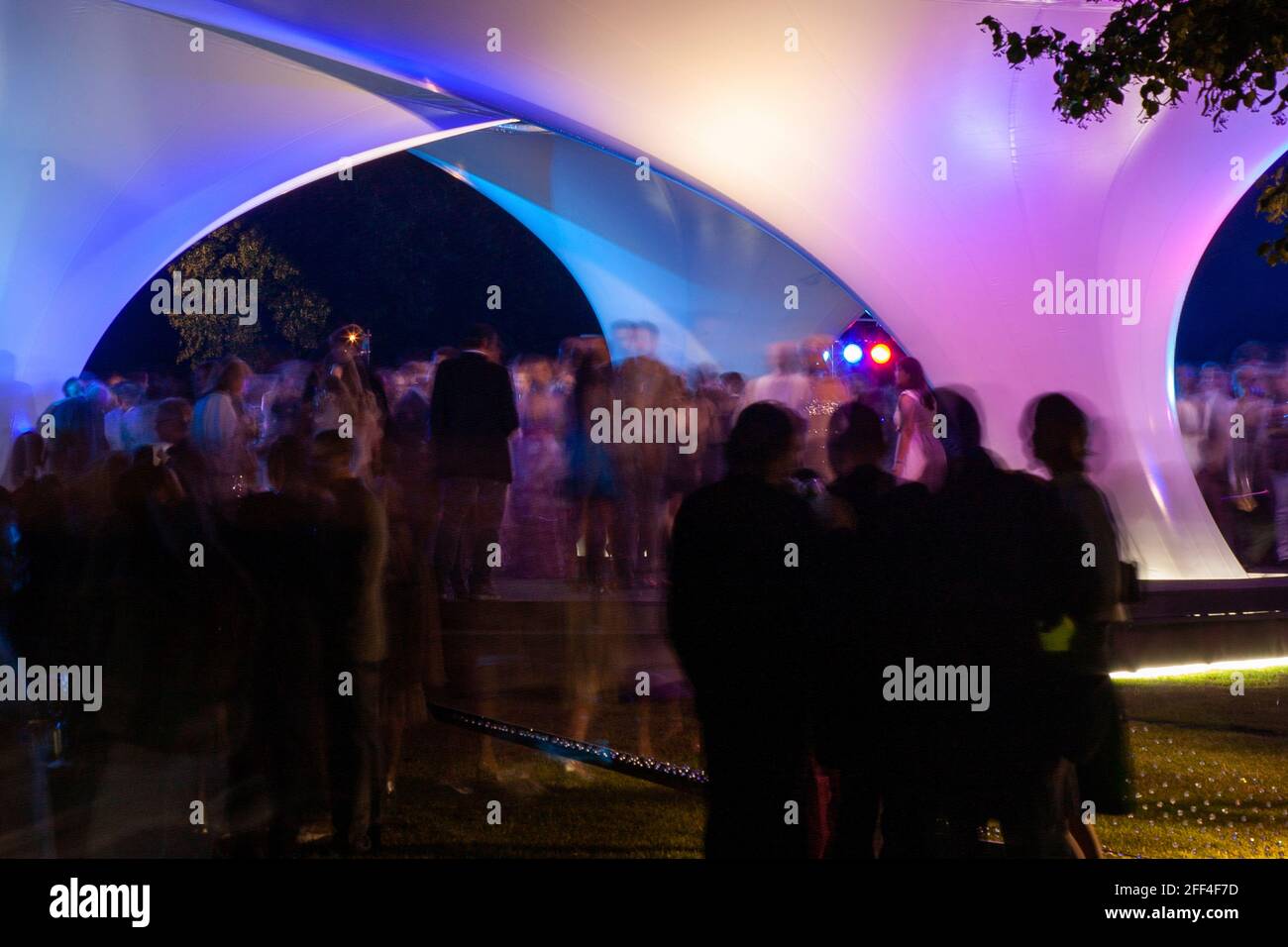 Crowds of people gathering outside Lilas, for the Serpentine summer party. Lilas Pavilion - Serpentine Gallery, London, United Kingdom. Architect: Zah Stock Photo