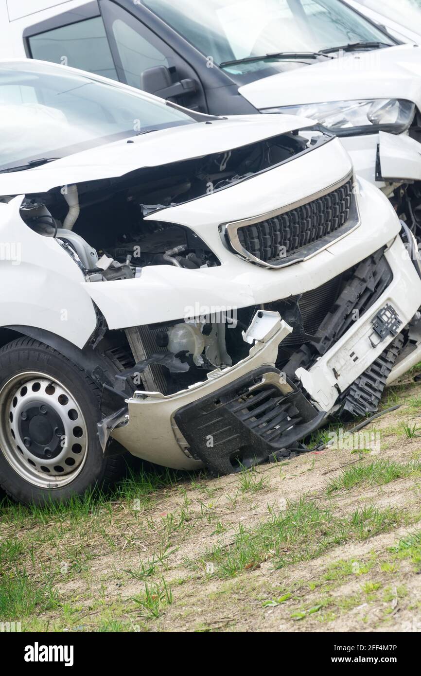 Broken car white van after frontal collision. Closeup. Stock Photo