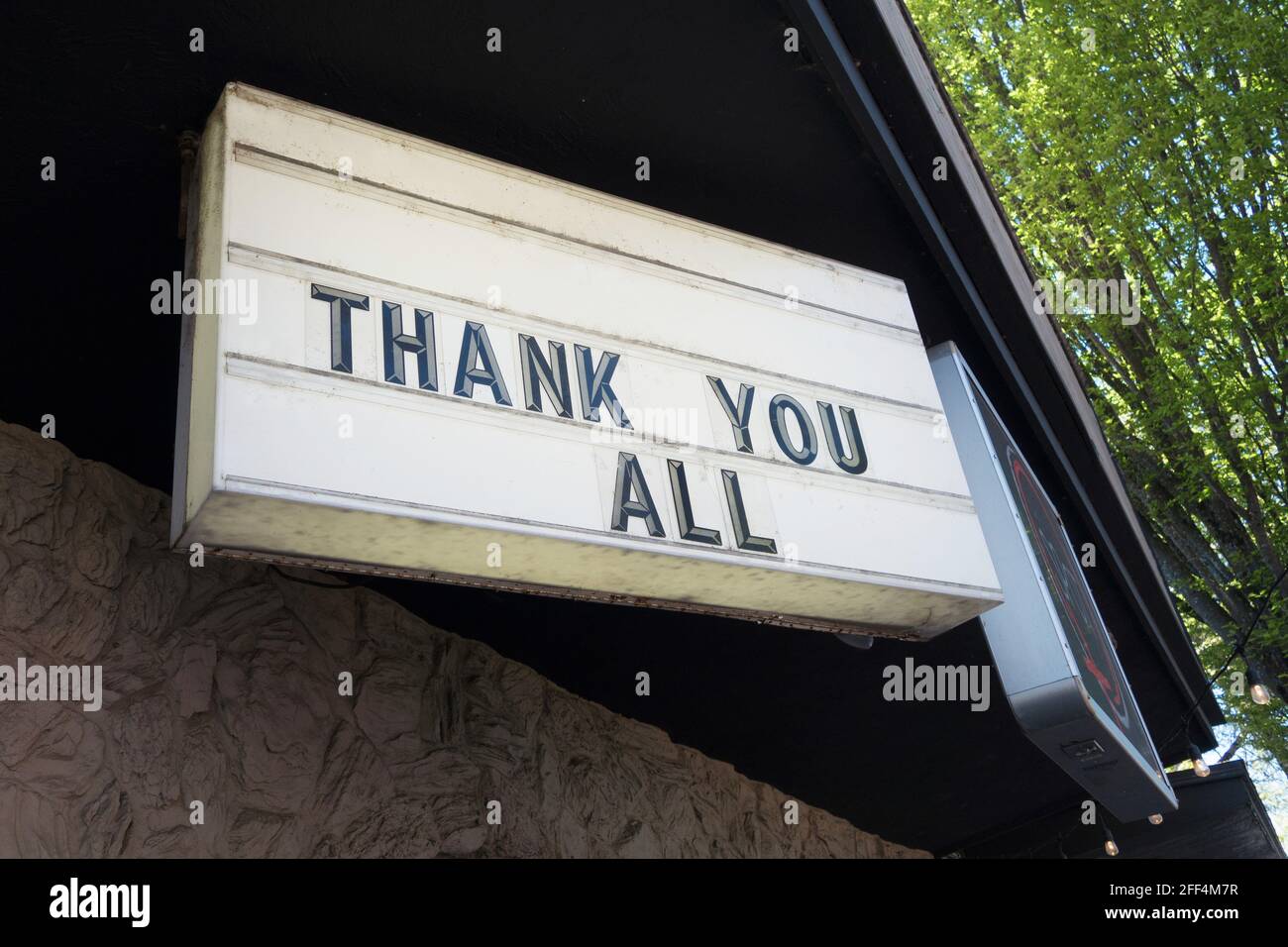 A large sign that reads "thank you all" on a business. Stock Photo
