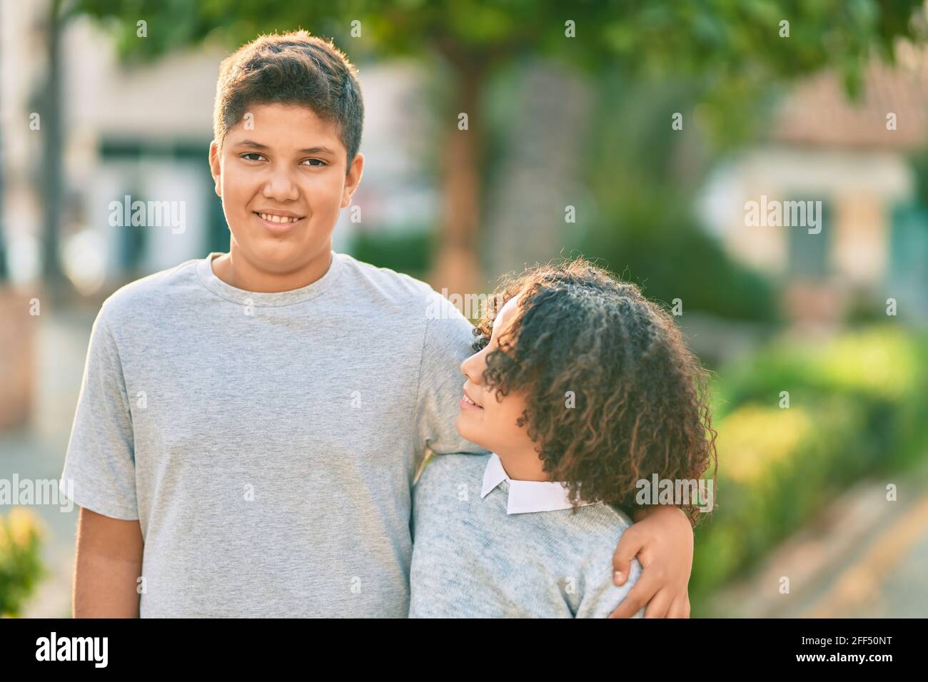 Adorable latin brother and sister hugging at the park Stock Photo - Alamy