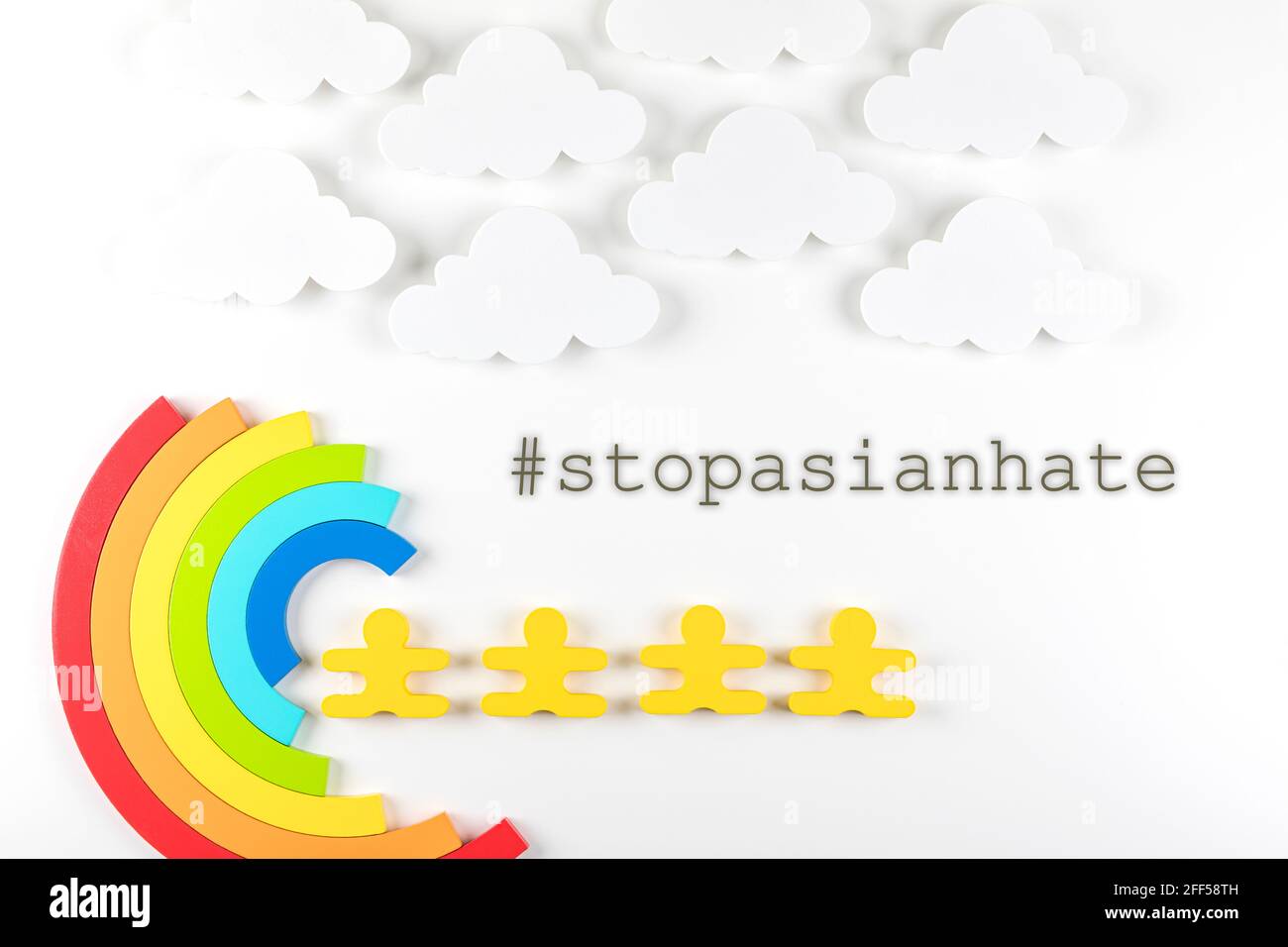 Writing Stop Asian Hate with rainbow on white background. Hate crimes against Asians. Virus has no nationality. Concept of end racism. Stock Photo