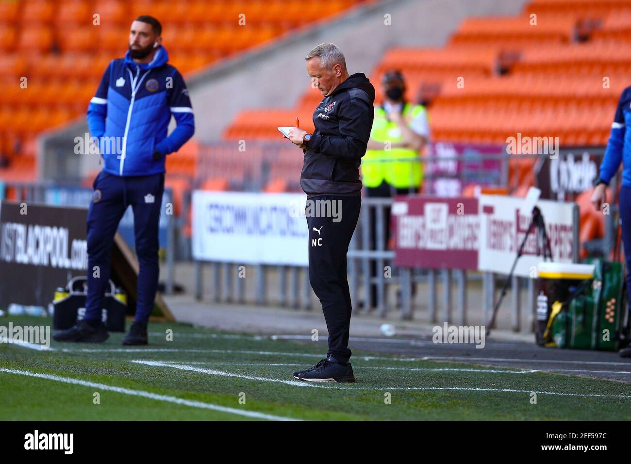 Bloomfield Road, Blackpool, UK. 24th Apr, 2021. Neil Critchley Manager of Blackpool taking notes during the game Blackpool v Shrewsbury Sky Bet League One 2020/21 Bloomfield Road, Blackpool, England - 24th April 2021 Credit: Arthur Haigh/Alamy Live News Stock Photo