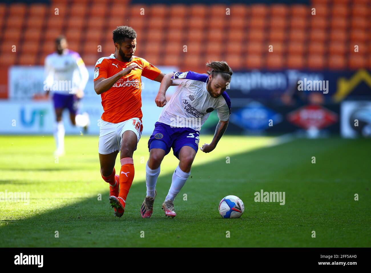 Bloomfield Road, Blackpool, UK. 24th Apr, 2021. Harry Chapman (32) of Shrewsbury holds of the challenge from Grant Ward (18) of Blackpool during the game Blackpool v Shrewsbury Sky Bet League One 2020/21 Bloomfield Road, Blackpool, England - 24th April 2021 Credit: Arthur Haigh/Alamy Live News Stock Photo