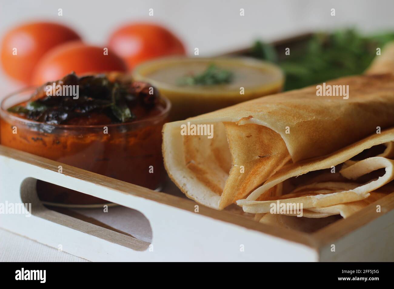 Crispy pancake made of rice and lentils. Served with tomato chilly