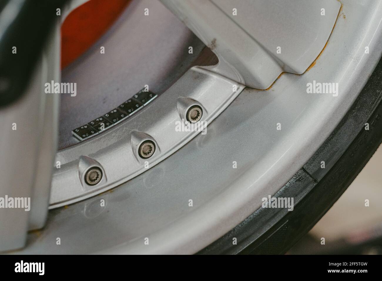 Closeup of the rim of a car tire with iron balancing weights on it Stock Photo