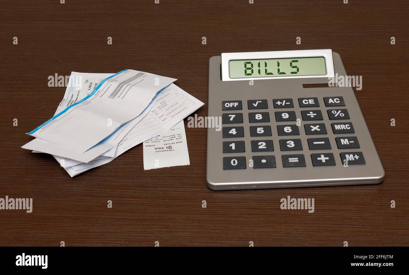 Home utilities and other bills pile calculating on large electronic ...