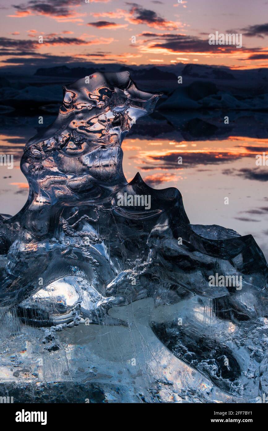 Some of the icebergs floating by are totally translucid providing several refractions of light in the ice Stock Photo