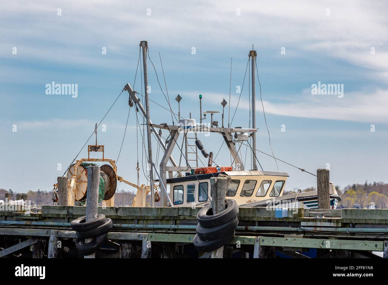 Commercial fishing boat tied up a dock in Greenport, NY Stock Photo