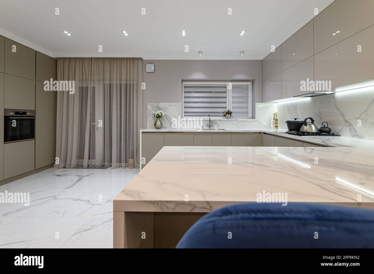 Luxury white modern marble kitchen in studio space Stock Photo - Alamy