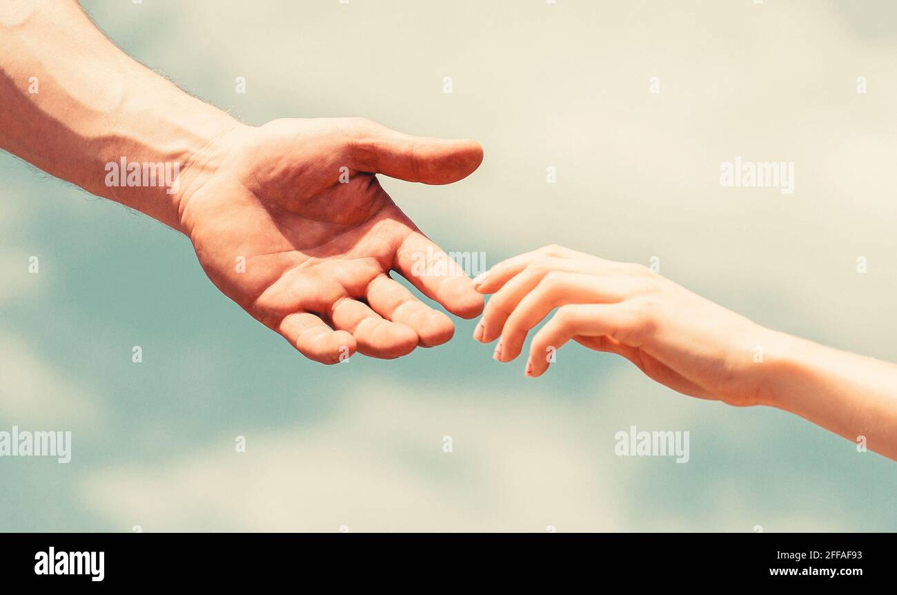 Hands of man and woman reaching to each other, support. Giving a helping  hand. Hands of man and woman on blue sky background. Lending a helping hand  Stock Photo - Alamy