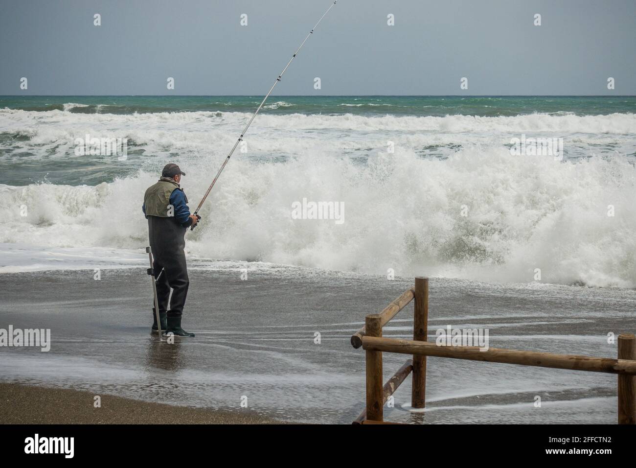 Angler at sea, during rough sea, Spain. Stock Photo