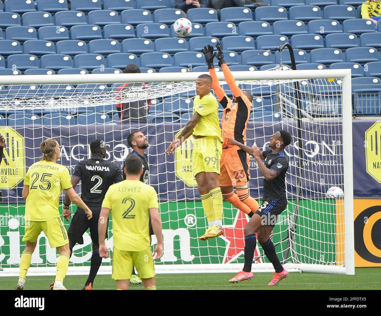 Nashville TN, USA. 24th Apr, 2021. CF MontrŽal goalkeeper Clement Diop (23) blocks the ball as Nashville SC forward Jhonder Cadiz (99) tries to head the ball during the second half of an MLS game between the FC Montreal and the Nashville SC at Nissan Stadium in Nashville TN. Credit: csm/Alamy Live News Stock Photo