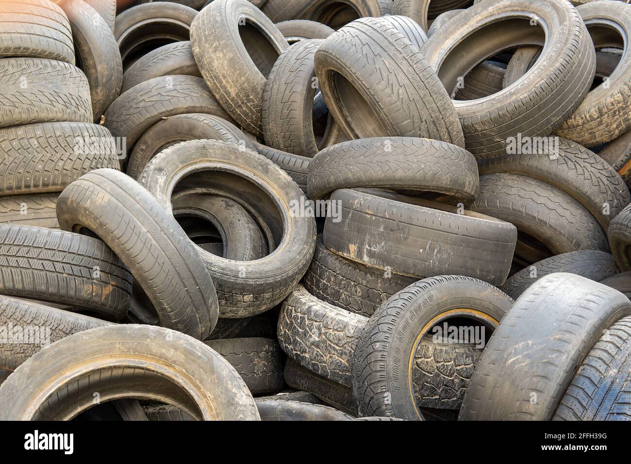 Rubber tires in a landfill. Old wheels from cars. Recycling rubber