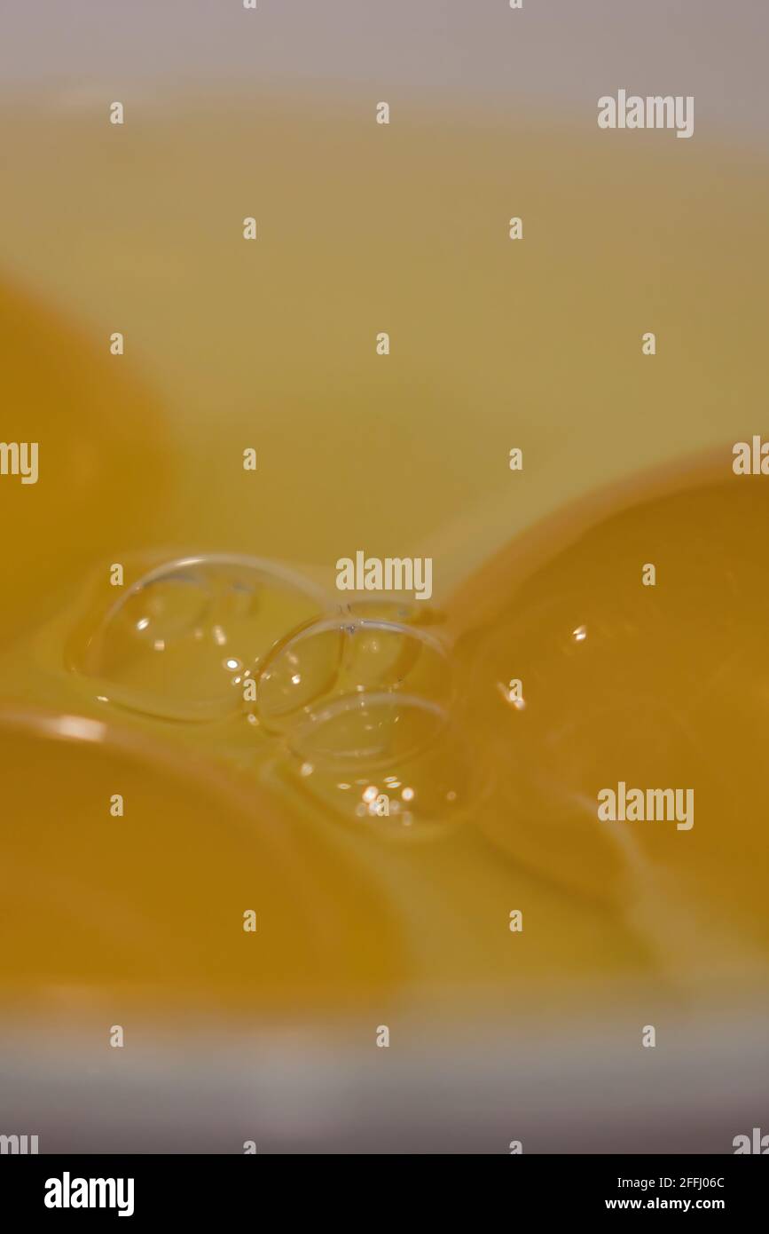 close up of three raw eggs cracked into a white bowl Stock Photo