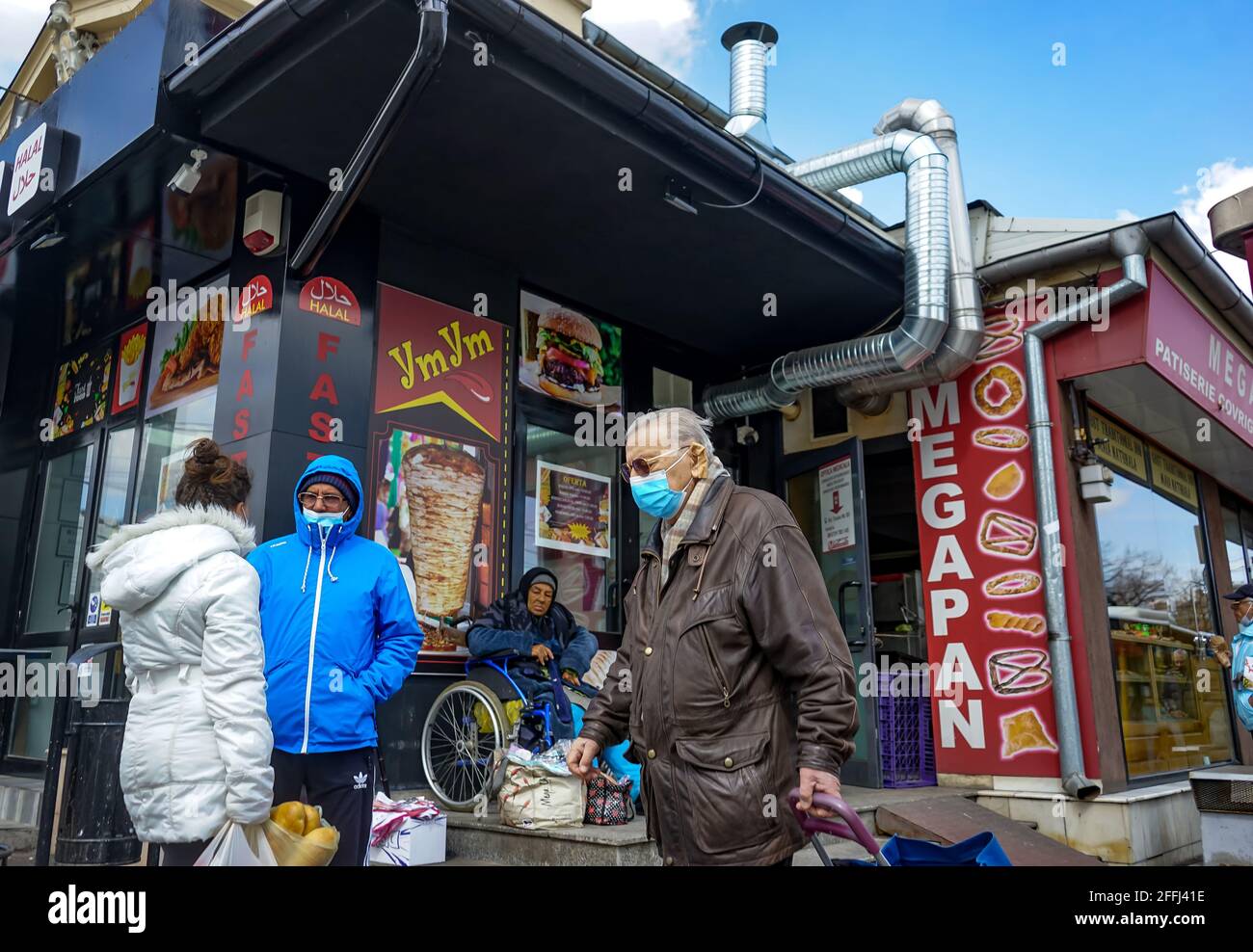 Bucharest, Romania - April 08, 2021: People in front of YmYm halal fat food restaurant, in Bucharest. Stock Photo