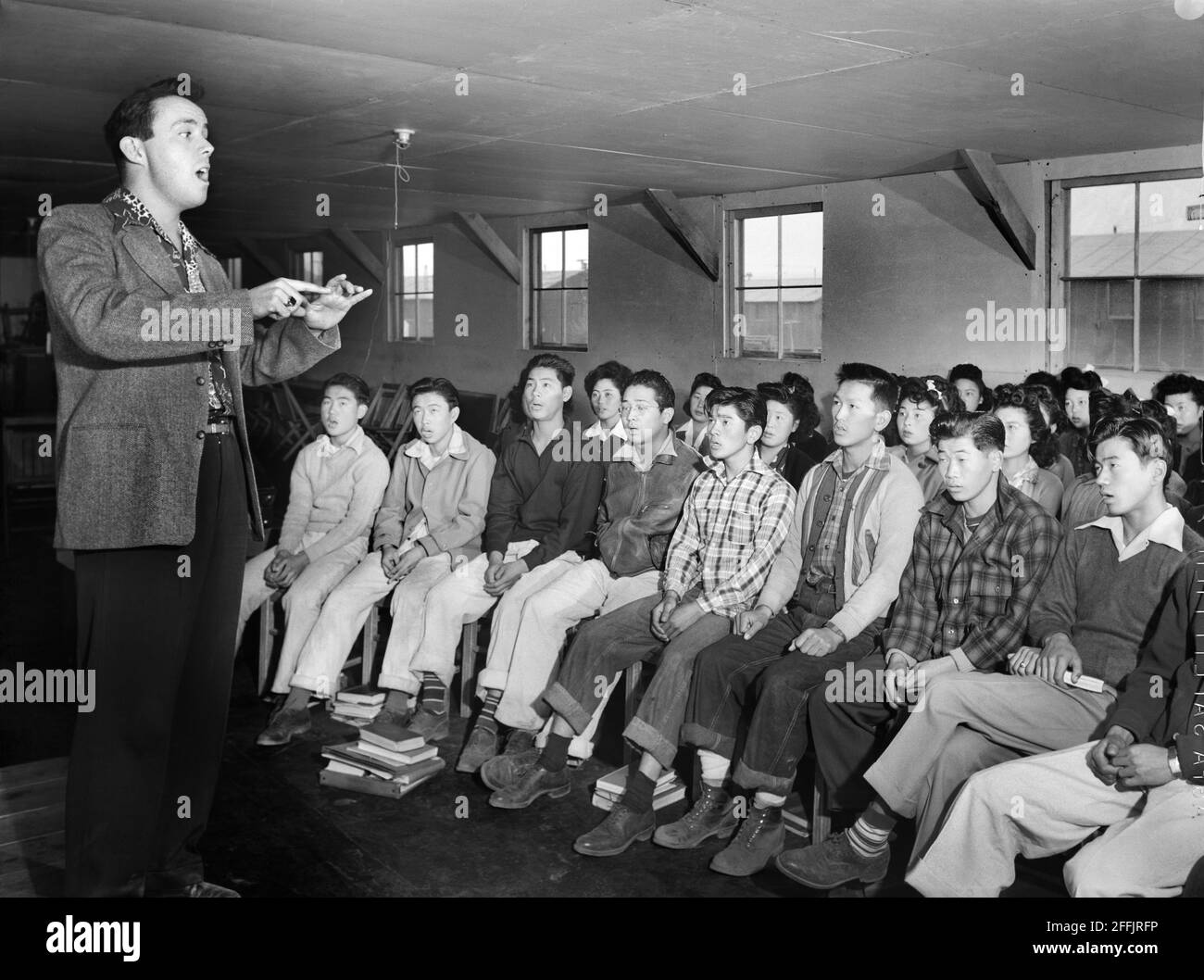 Choir Group with Director Louie Frizzell, Manzanar Relocation Center, California, USA, Ansel Adams, Manzanar War Relocation Center Collection, 1943 Stock Photo