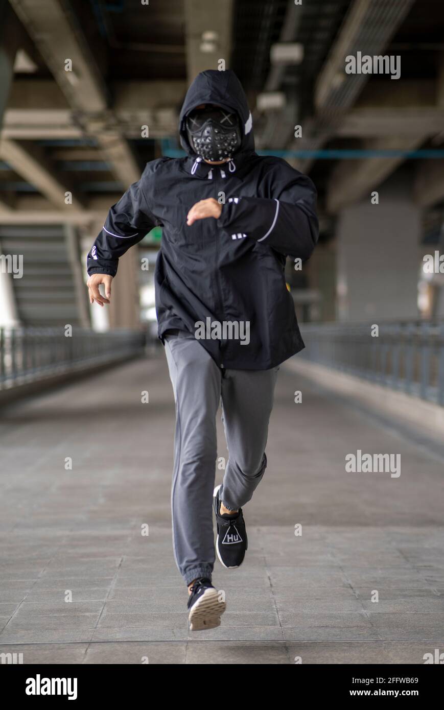 Studded black mask on man dressed in black hoodie Stock Photo Alamy