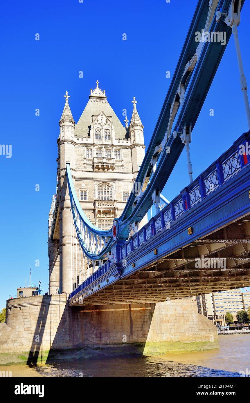 London, England, United Kingdom. A portion of the span leading to the bridge and twin towers of iconic Tower Bridge basking in the afternoon sun. Stock Photo