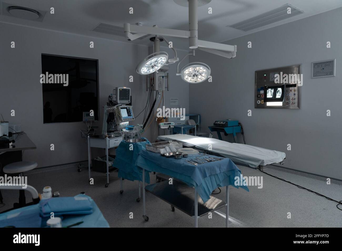 Surgical instruments, operating table, lights and equipment in modern hospital operating theatre Stock Photo
