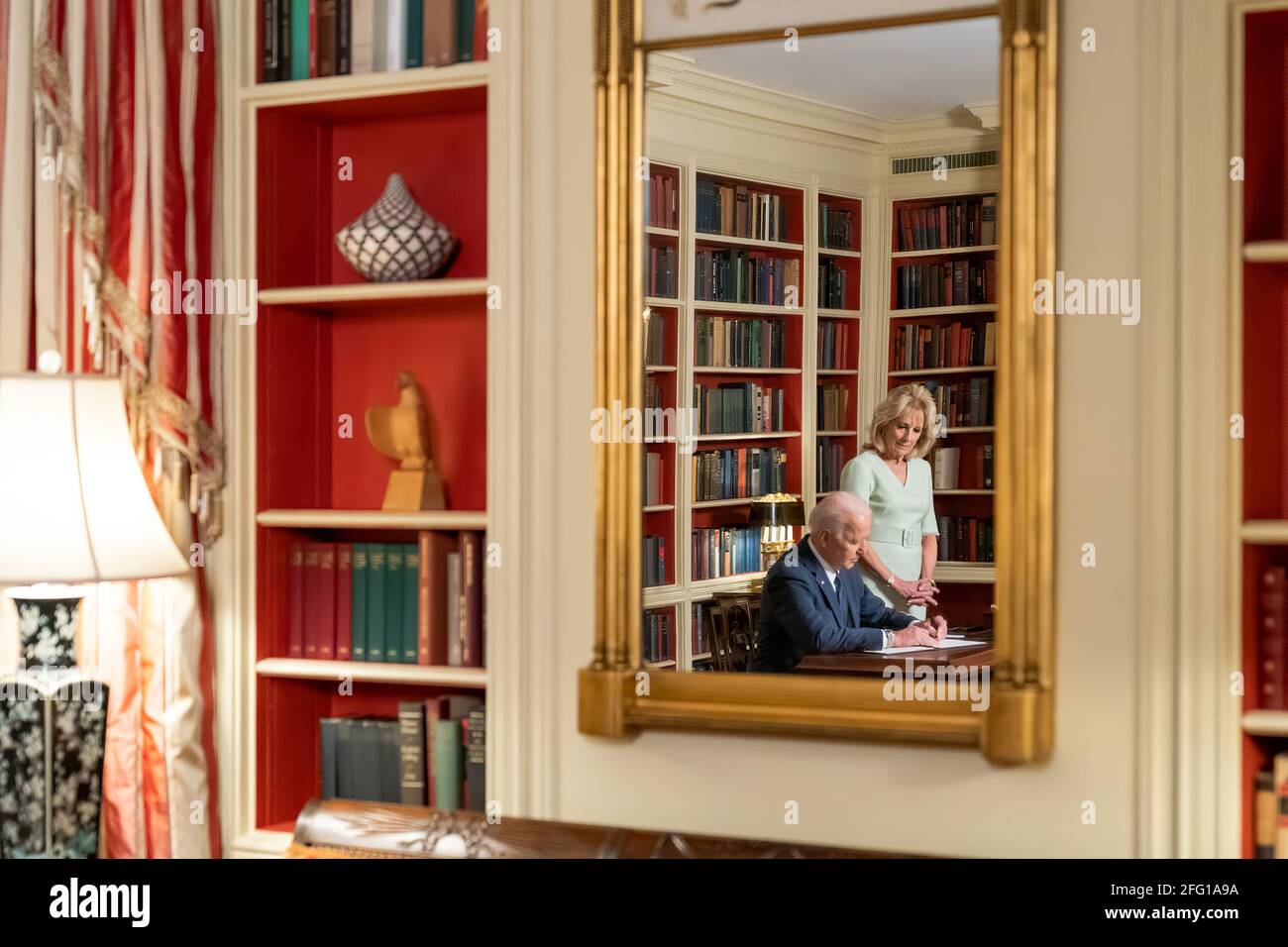 President Joe Biden, joined by First Lady Jill Biden, signs the Month