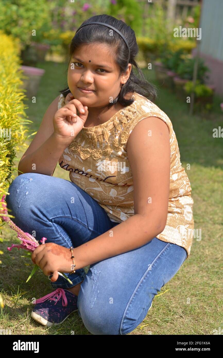 Teenage Indian Bengali girl posing for photo in a garden, selective