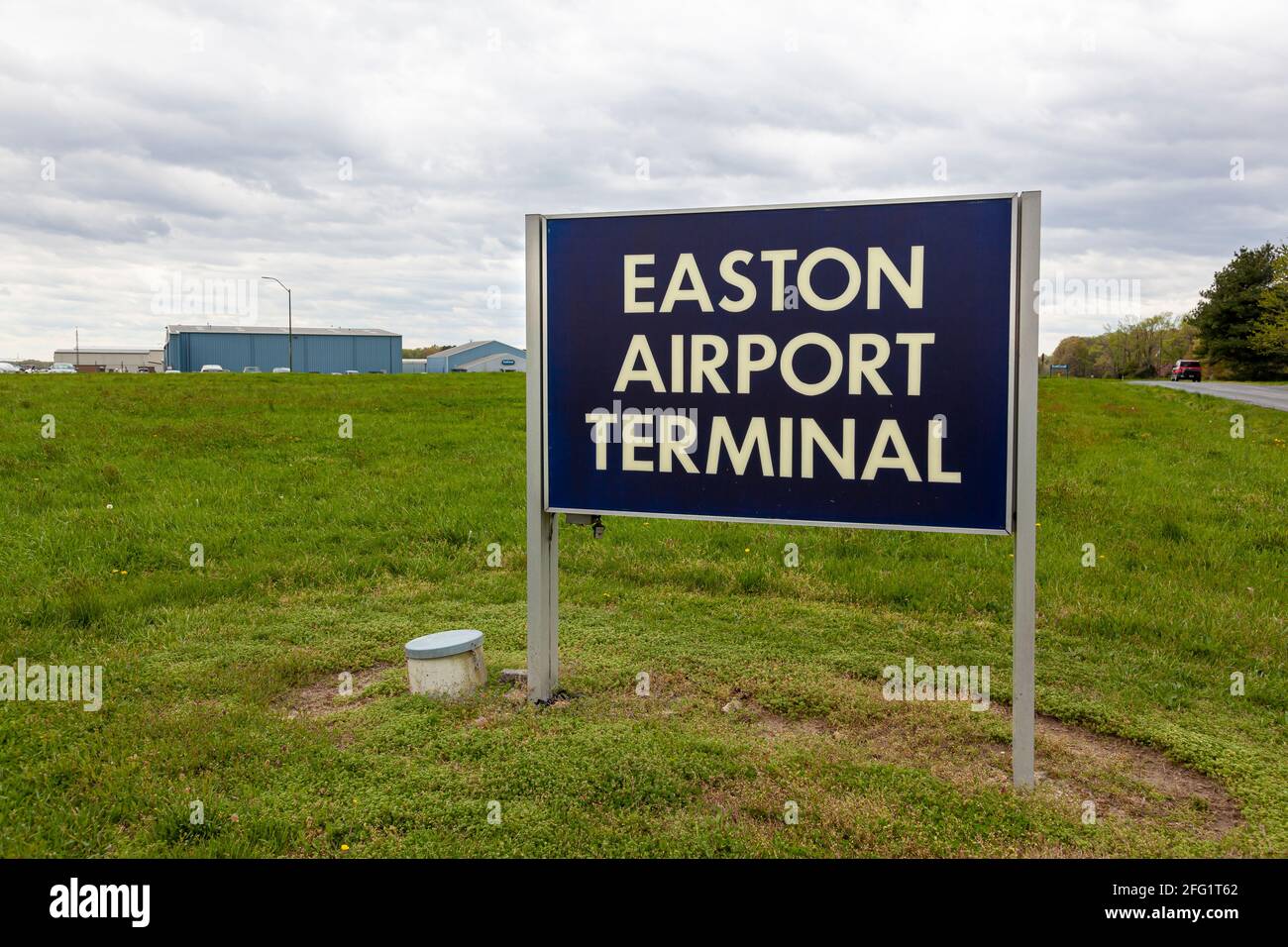 Easton, MD, USA 04-16-2021: Image  of the sign of Easton Airport (ESN) owned by Talbot County for public use. Image shows, hangars, and terminal from Stock Photo