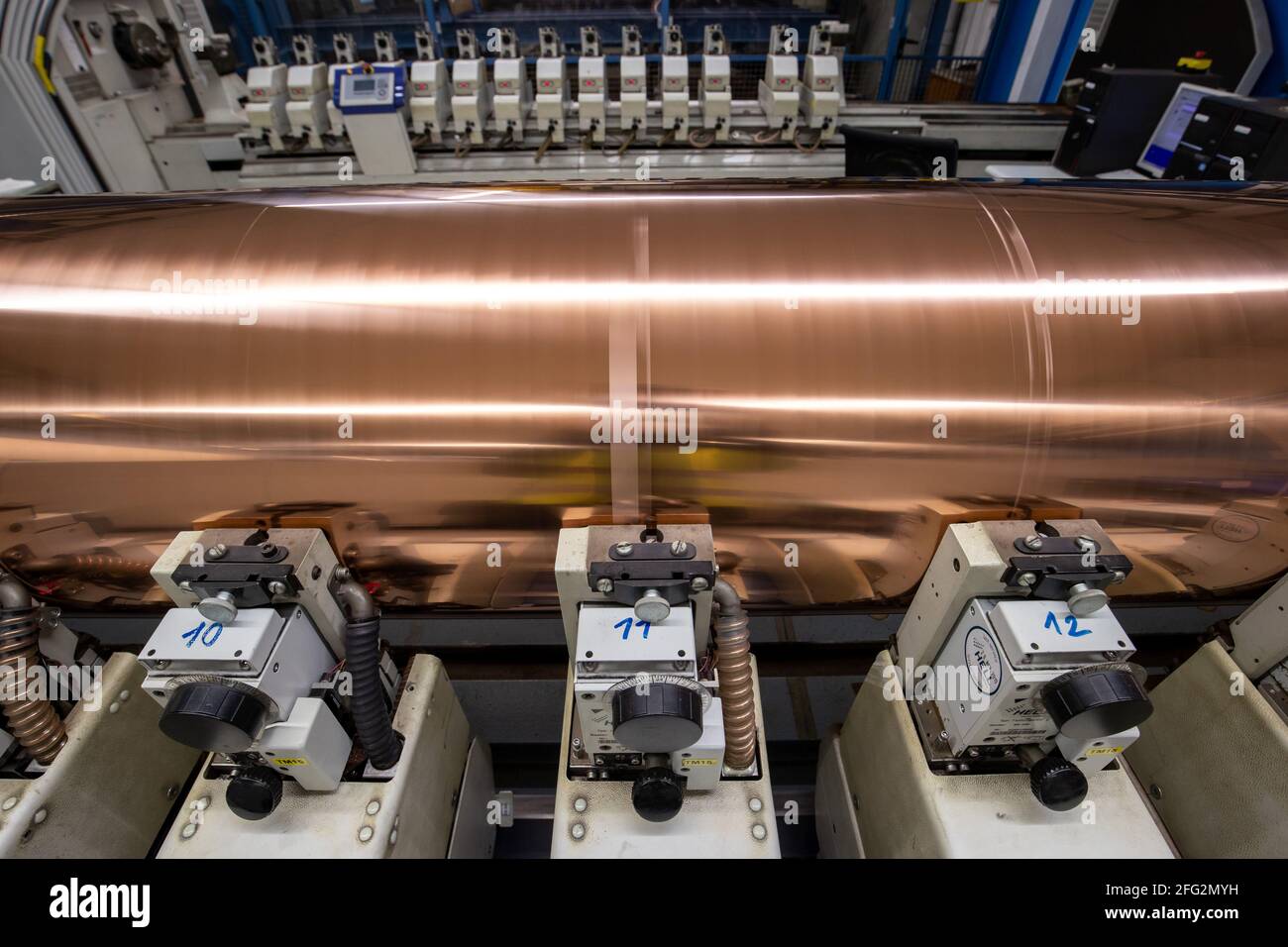 Nuremberg, Germany. 19th Apr, 2021. A rotating copper-plated gravure cylinder is engraved at the Prinovis printing plant. The Nuremberg-based large-scale printing plant of the Prinovis Group, which is part of the Bertelsmann Group, will close on April 30, 2021. Credit: Daniel Karmann/dpa/Alamy Live News Stock Photo