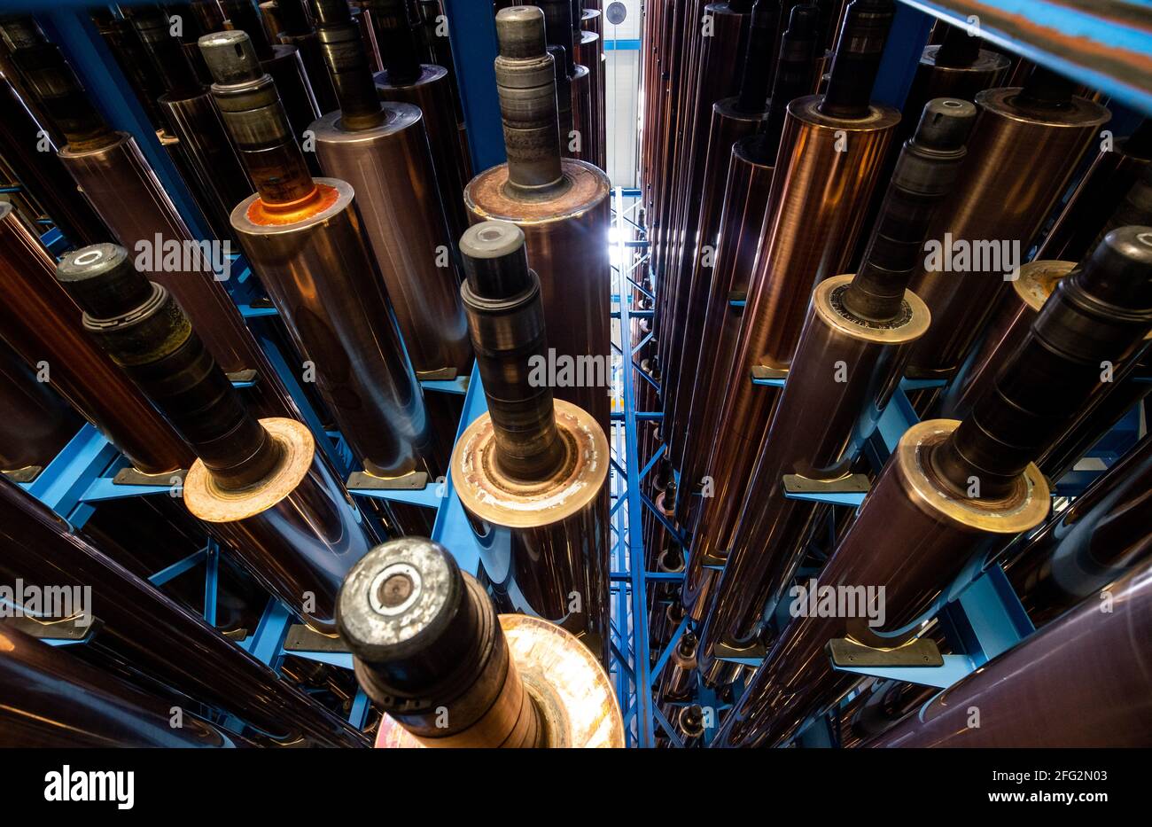 Nuremberg, Germany. 19th Apr, 2021. Copper-plated gravure cylinders lie on shelves in a warehouse at the Prinovis printing company. The Nuremberg-based large-scale printing plant of the Prinovis Group, which is part of the Bertelsmann Group, will close on April 30, 2021. Credit: Daniel Karmann/dpa/Alamy Live News Stock Photo