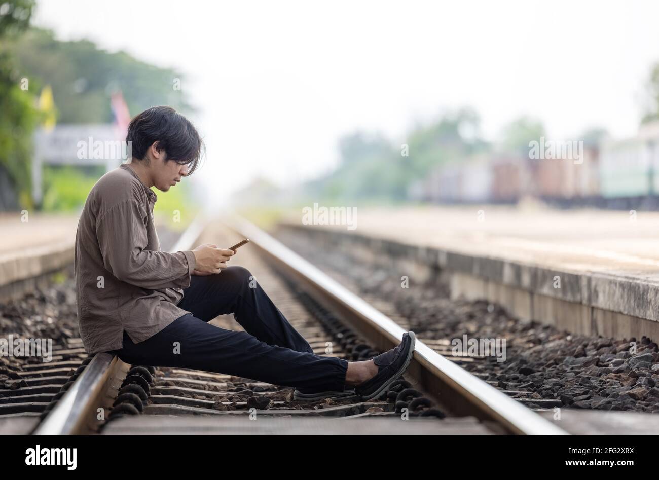Everyday Lifestyle Concept. Handsome Man Wears Sweater and Jeans, Poses at  Rail Station Platform, Leans at Bag, Has Telephone Stock Photo - Image of  device, shot: 135308672