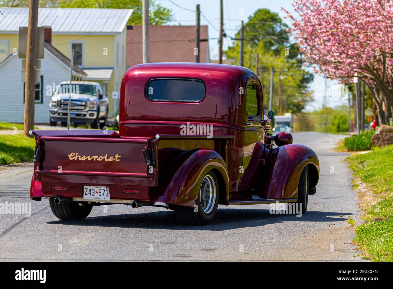 Vienna, MD, USA 04-16-2021: A vintage red shiny Chevrolet Master series pickup truck (built between 1933-1940) is on the road at a residential neighbo Stock Photo