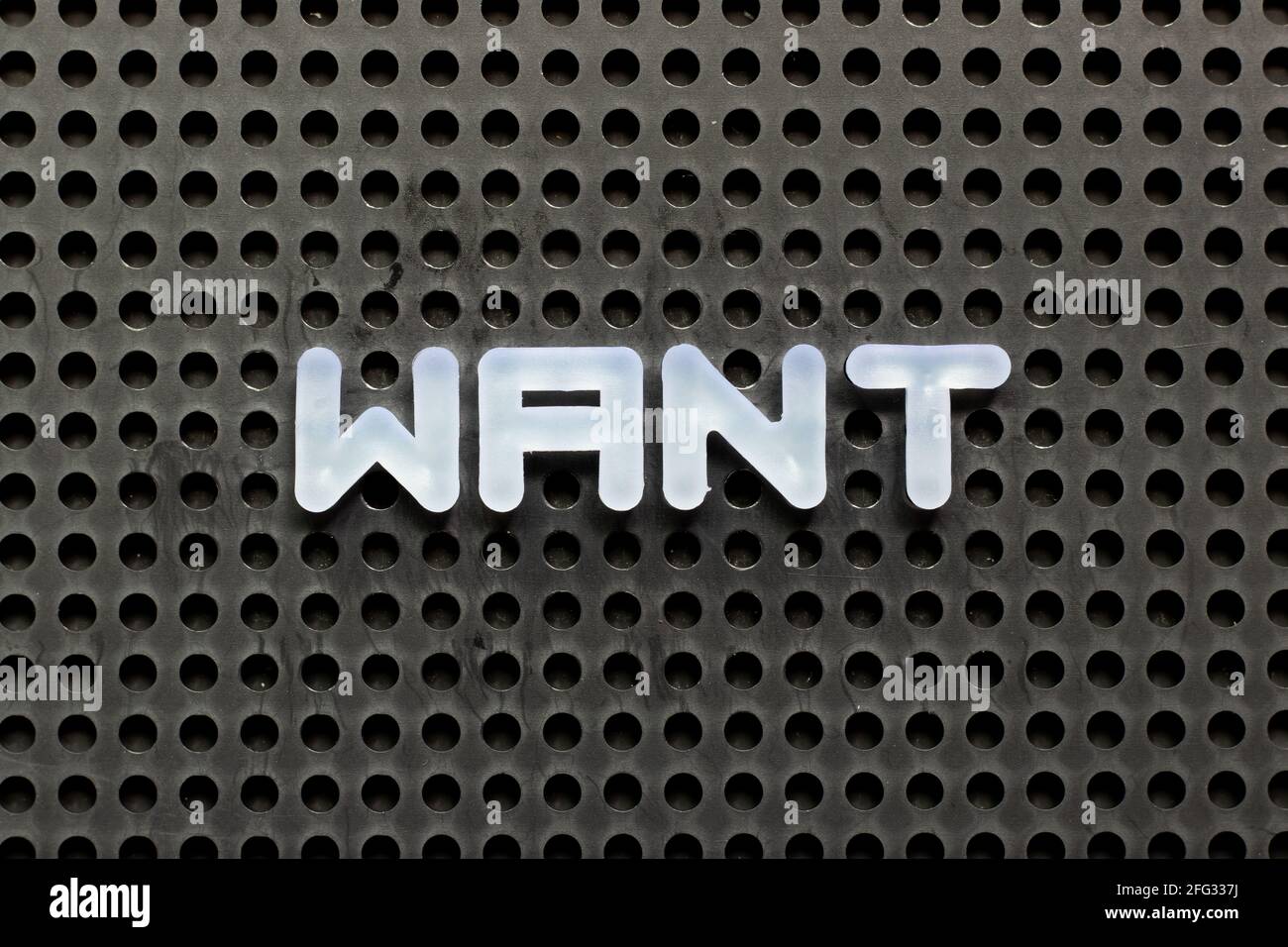 White color letter in word want on black pegboard background Stock ...