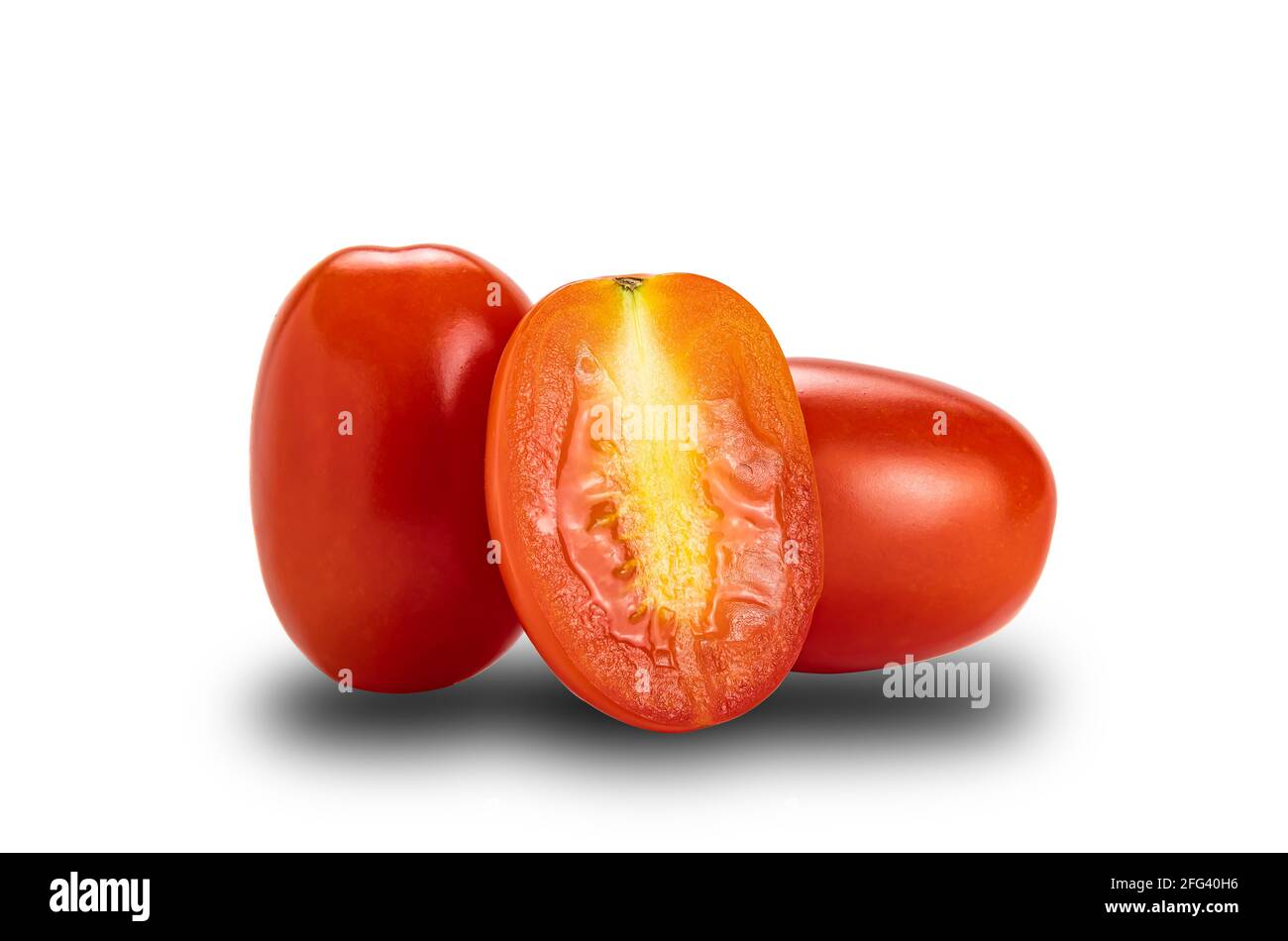 Side view of whole and a half ripe plum tomatoes on white background with clipping path. Tomatoes or Solanum lycopersicum or lycopersicon esculentum a Stock Photo