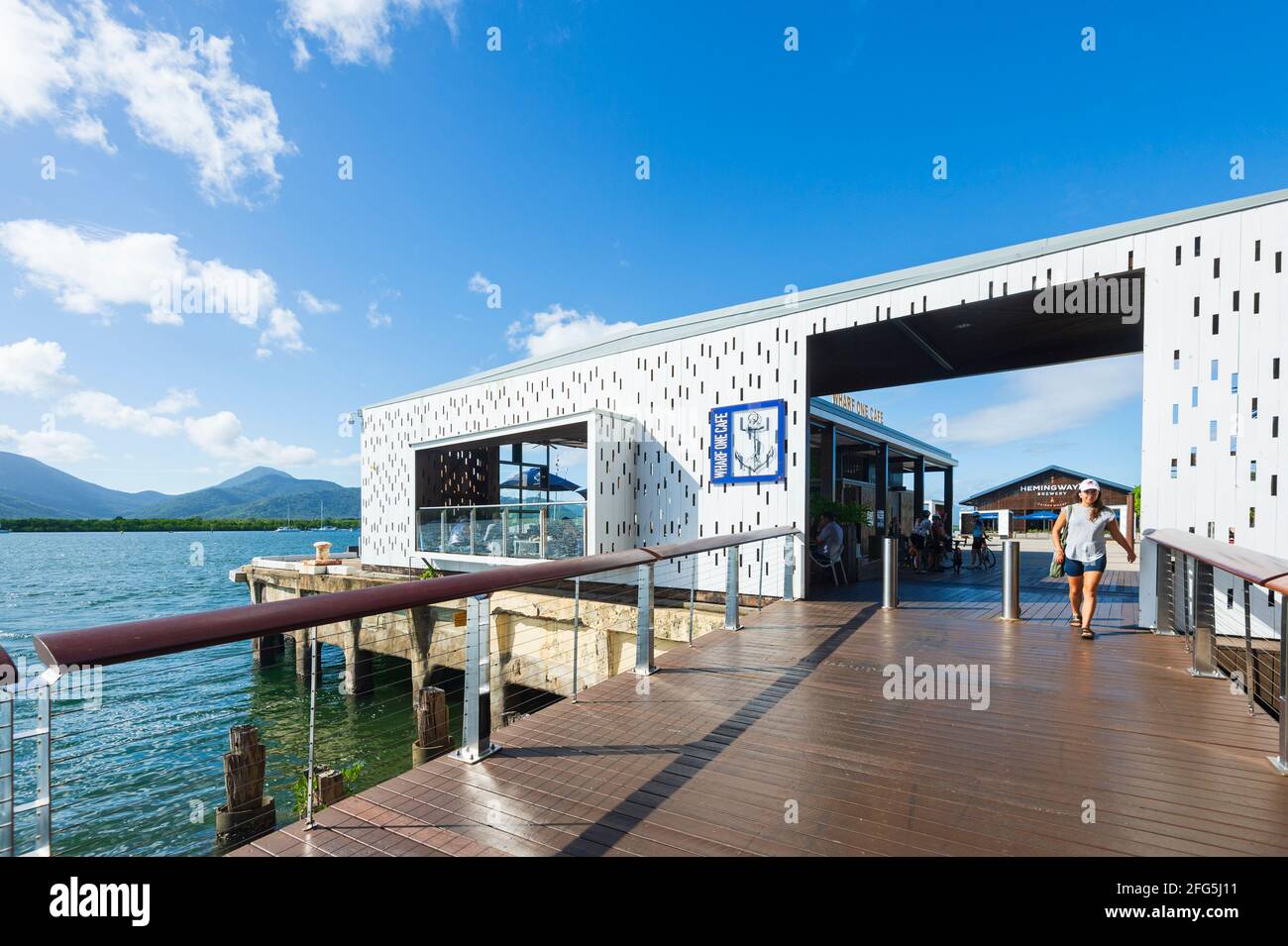 Young strolling past Wharf One Café on the Trinity Inlet foreshore